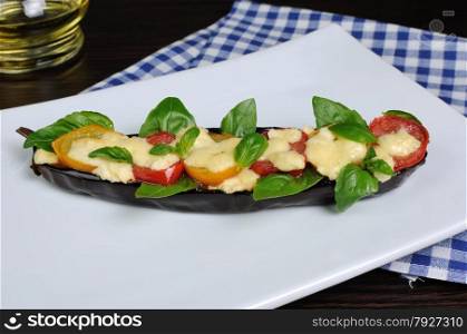 Baked eggplant with tomato cheese and basil