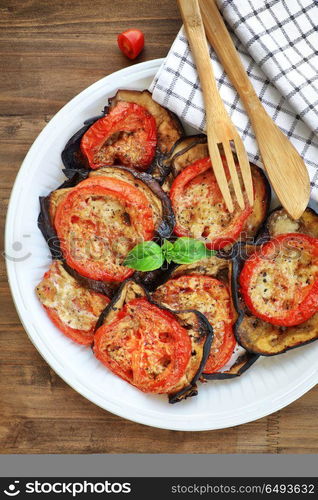 Baked eggplant with tomatoes as tasty vegetarian pizza topping, traditional italian food, organic nutrition