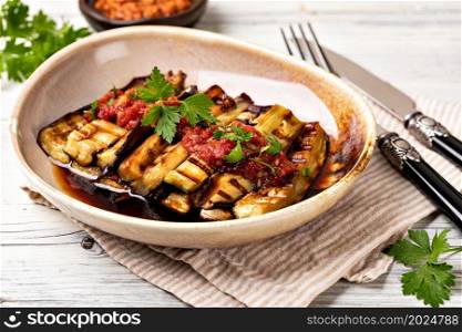 Baked eggplant with tomatoes, garlic and paprika. Grilled eggplant and sauce