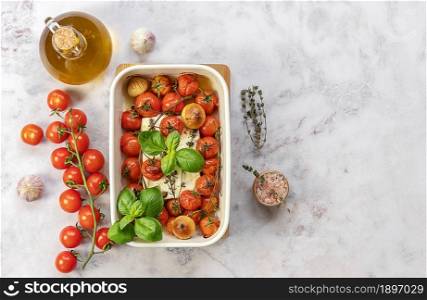 Baked feta cheese with tomatoes, capers, garlic, herbs, and olive oil. In the oven it turns into an amazing sauce by itself. Just add some cooked pasta, mix, and enjoy. viral trendy recipe.