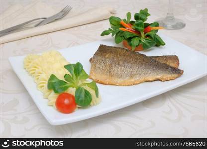 Baked fillet of sea bass with vegetables and mashed potato mix