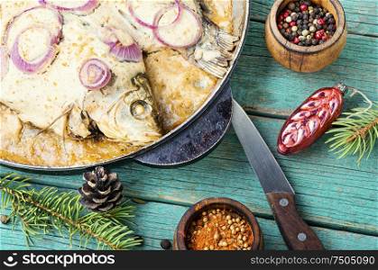 Baked fish in sour cream sauce to the Christmas table.Fish food.. Baked fish for christmas