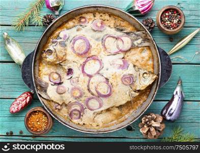 Baked fish in sour cream sauce to the Christmas table.Fish food.. Baked fish for christmas