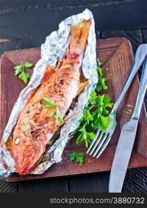 baked fish in the foil and on a table