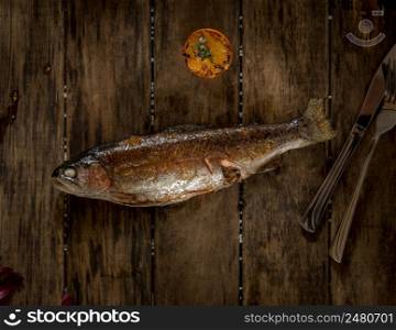baked fish on wooden boards, top view. dish on a wooden surface