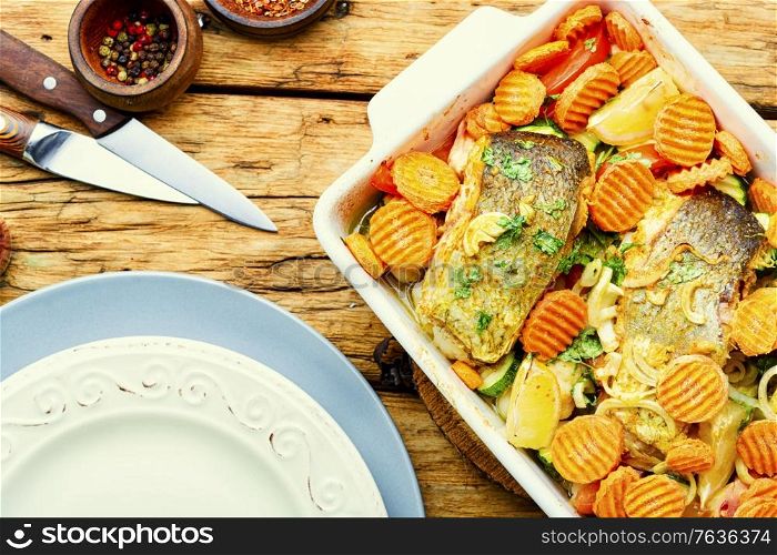 Baked fish steaks with grilled vegetables in baking dish.Delicious healthy grilled fish. Grilled fish with roasted vegetables