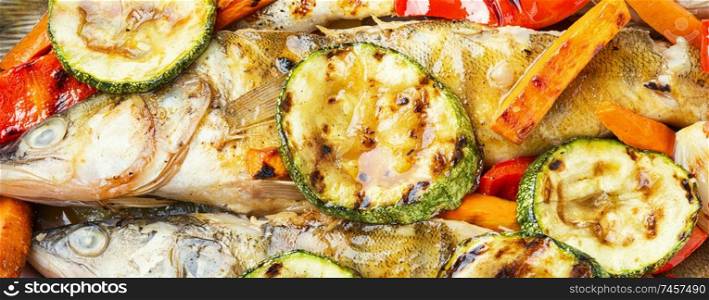 Baked fish with vegetable garnish.Baked pike perch with zucchini and pepper.Fish food. Delicious roasted fish
