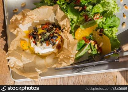 Baked goat cheese Mediterranean in parchment paper. Baked goat cheese Mediterranean in parchment paper.
