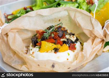 Baked goat cheese Mediterranean in parchment paper. Baked goat cheese Mediterranean in parchment paper.