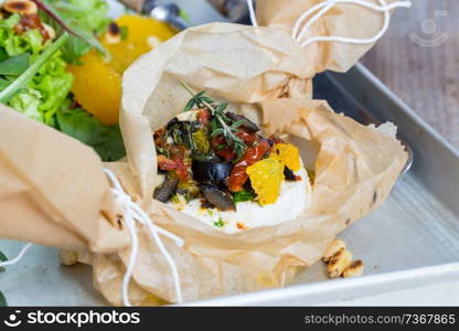 Baked goat cheese Mediterranean in parchment paper.. Baked goat cheese Mediterranean in parchment paper
