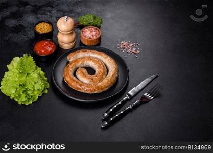 Baked homemade sausage with spices and herbs, close up. Spiral grilled homemade sausage. Baked homemade sausage with spices and herbs, close up