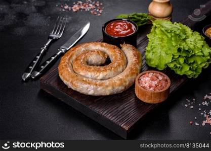 Baked homemade sausage with spices and herbs, close up. Spiral grilled homemade sausage. Baked homemade sausage with spices and herbs, close up