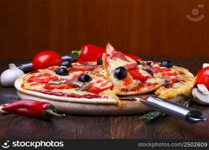 Baked hot pizza with one slice on lifter