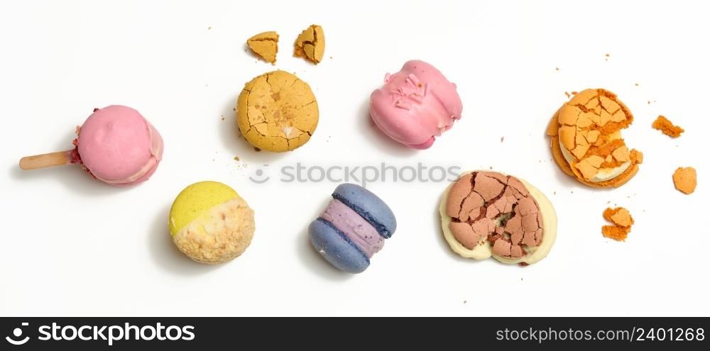 baked macarons with different flavors on a white background, top view