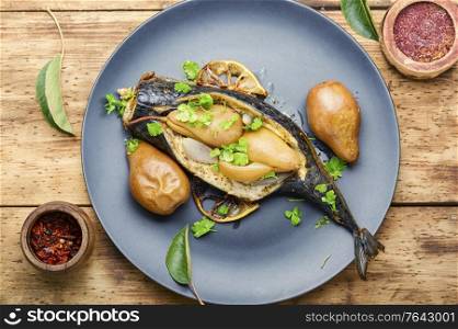Baked mackerel fish stuffed with autumn pear.Grilled mackerel with pears. Mackerel stuffed with pear
