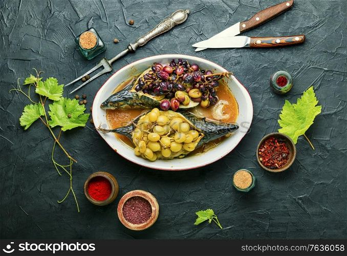 Baked mackerel or scomber in grape berry sauce.Fish food. Baked fish with grape sauce