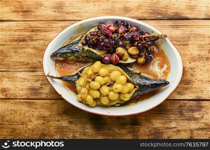 Baked mackerel or scomber in grape berry sauce.Roasted fish. Baked fish with grape sauce