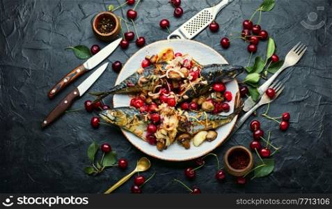 Baked mackerel with cherry sauce.Fish filled with berries.Scomber on the plate. Grilled mackerel fish stuffed with cherries