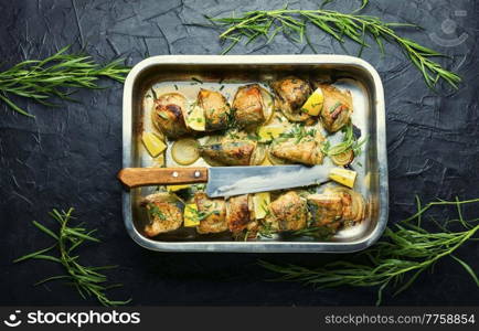 Baked mackerel with onions and herbs.Roasted fish in a baking dish.Seafood. Sliced baked mackerel on an onion pillow