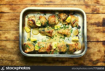 Baked mackerel with onions and herbs.Roasted fish in a baking dish. Seafood. Baked mackerel on an onion pillow