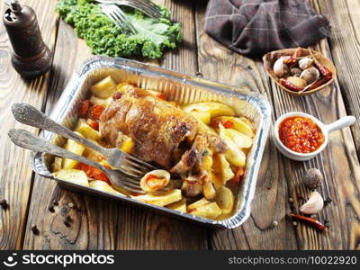 baked meat and potatoes on a baking sheet