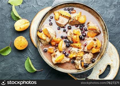 Baked meat in red wine with apricot and blackcurrant.Stewed pork.. Stew meat with apricot.