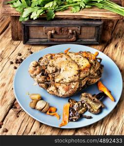 Baked meat, stuffed with mushrooms. Baked meat grill with mushrooms on a wooden background