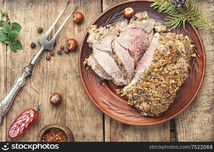 Baked meat under bread crust on festive table. Roasted beef for Christmas