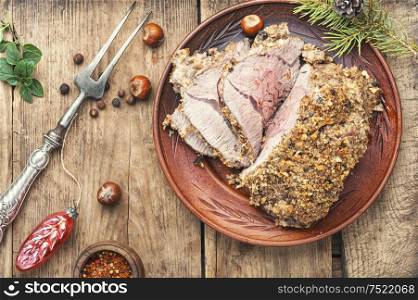 Baked meat under bread crust on festive table. Roasted beef for Christmas