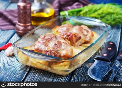 baked meat with potato in glass plate