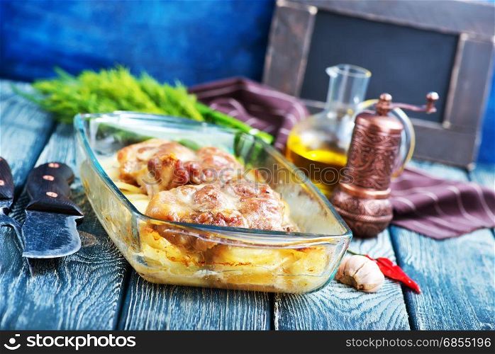 baked meat with potato in glass plate
