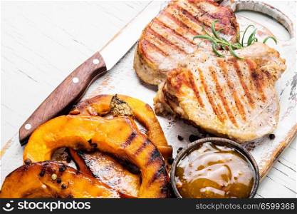 Baked meat with pumpkin on cutting board.Steak with pumpkin. Meat steak with pumpkin