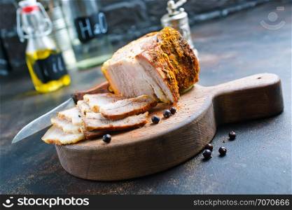 baked meat with spice on wooden board