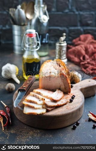 baked meat with spice on wooden board