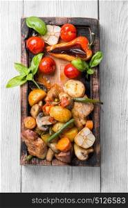 Baked meat with vegetables. Meat baked with potatoes and mushrooms in a rustic recipe