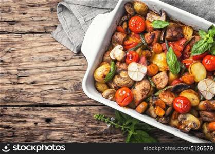Baked meat with vegetables. Meat baked with potatoes and mushrooms in rustic recipe. Copy space