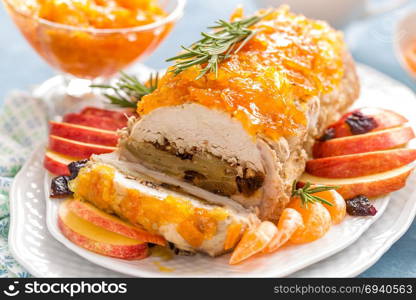 Baked meatloaf stuffed with apples and plums, decorated tangerine confiture. Christmas menu. Meat loaf stuffed with apples and plums, decorated tangerine confiture. Christmas menu