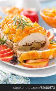 Baked meatloaf stuffed with apples and plums, decorated tangerine confiture. Christmas menu. Meat loaf stuffed with apples and plums, decorated tangerine confiture. Christmas menu