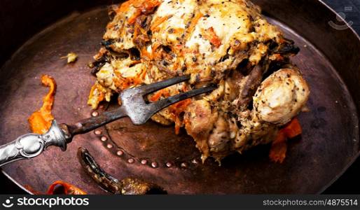 Baked meatloaf with spice on a wooden background. Baked meat pork