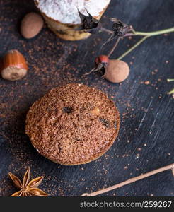 baked muffins on a black table, top view