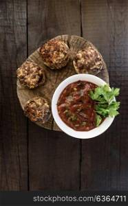 baked mushrooms with meat and sauce on a wood
