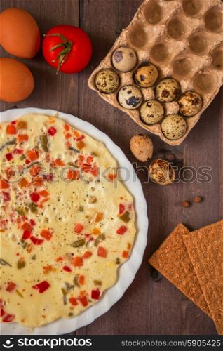 baked omelette. baked omelette with different eggs and vegetables with rye small load of bread