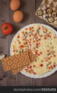 baked omelette. baked omelette with different eggs and vegetables with rye small load of bread