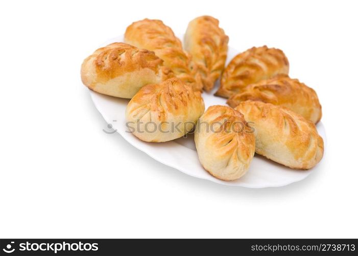 baked pasties on a plate against white background, clipping path, shallow DOF