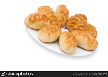baked pasties on a plate against white background, clipping path, shallow DOF