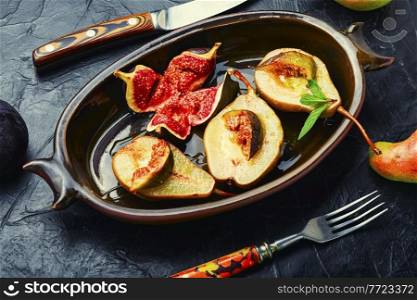 Baked pear halves with figs.Autumn vegan dessert. Baked pear with figs