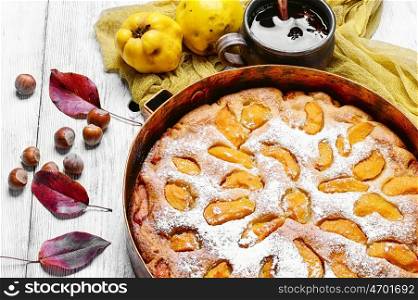 baked pie with quince. Baked pie with quince in copper kitchen form
