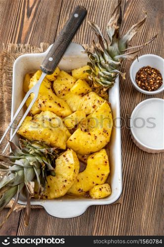 Baked pineapple with chilli flakes and whipped coconut cream