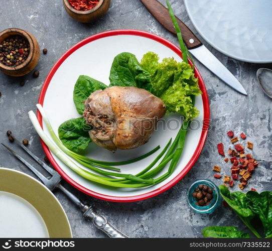 Baked pork heart stuffed with mushrooms and herbs. Dietary meat baked heart