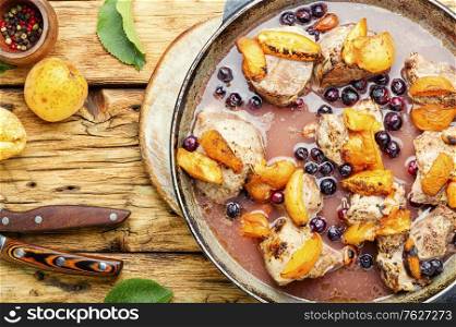Baked pork in red wine with apricot and berry. Stew meat with apricot.